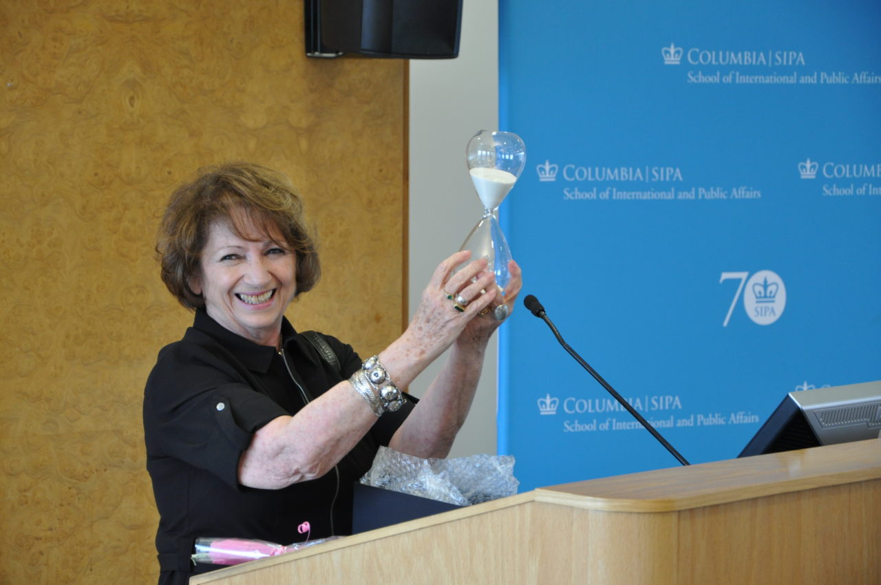 Anna Frajlich holding an hourglass award at a Columbia SIPA event